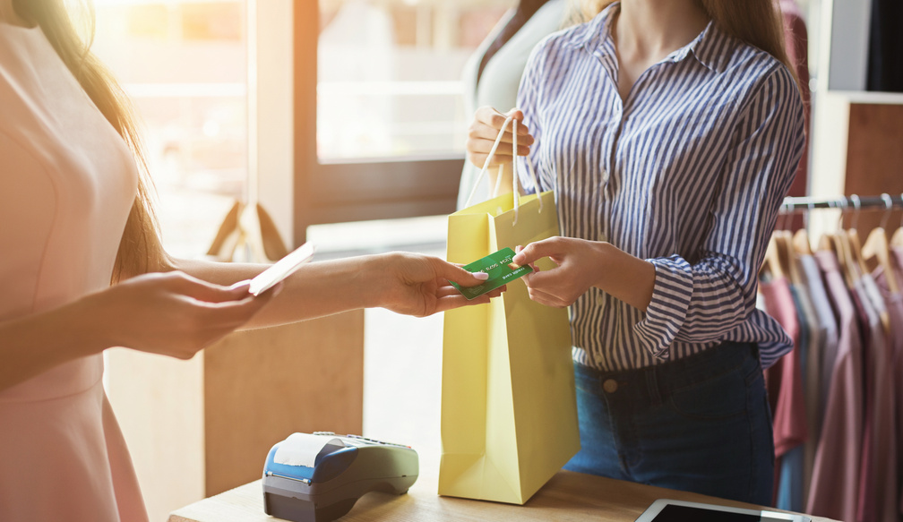 Woman purchasing clothes with credit card